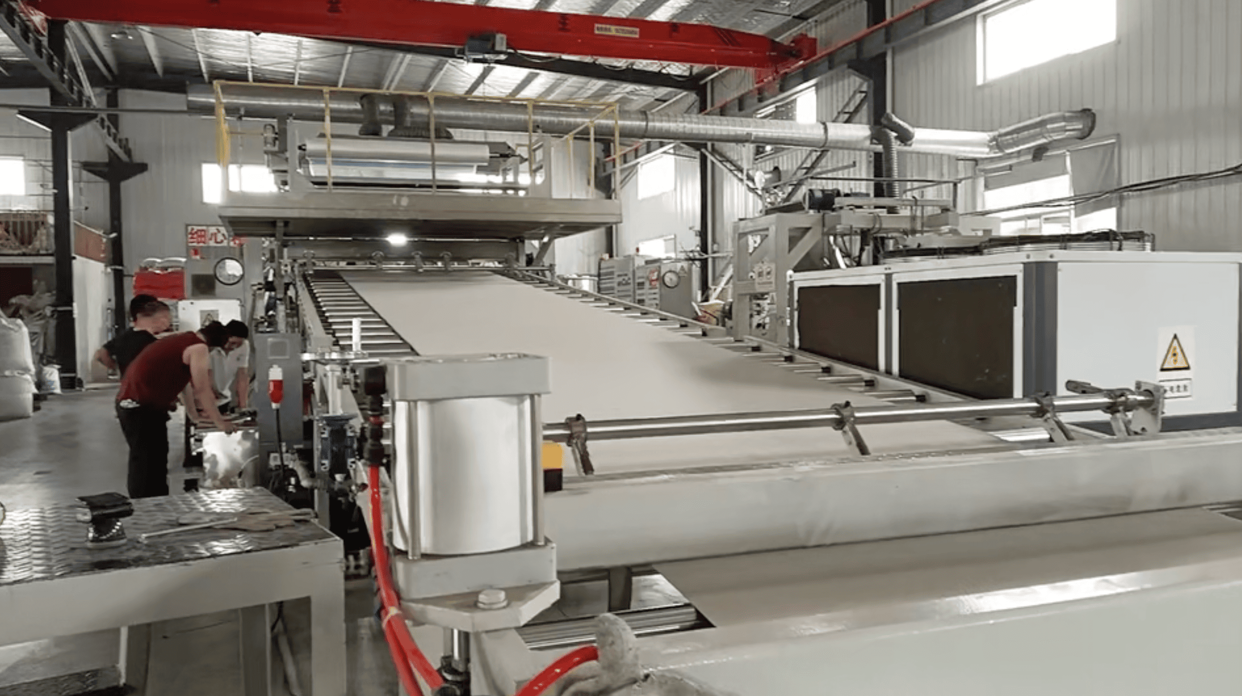 Continuous thermoplastic sheet moving through a production line